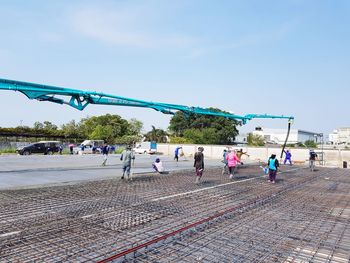 Group of people at stadium against blue sky