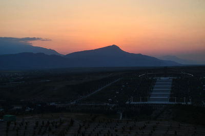 Scenic view of silhouette mountains against sky during sunset