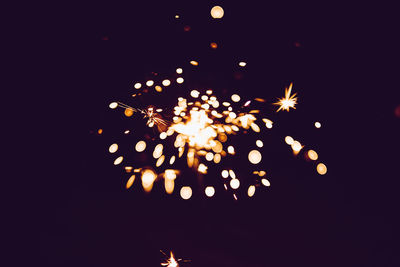 Low angle view of firework display at night