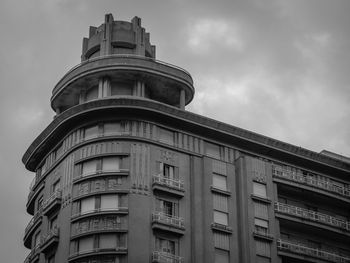 Low angle view of building against cloudy sky