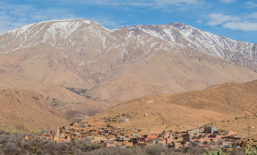 Scenic view of town against mountains