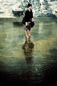 Full length of man standing in water