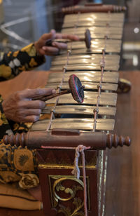 Midsection of man playing musical instrument