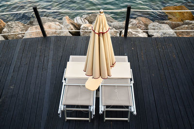 High angle view of chairs and tables at swimming pool