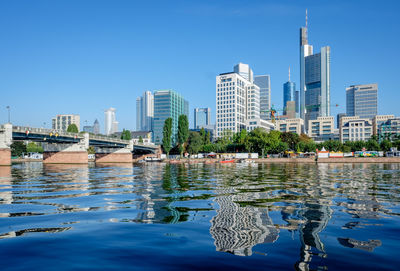 Untermainbrucke over main river in city against sky