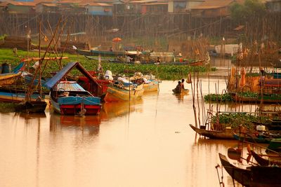 Traditional fishing boats on lake at sunset