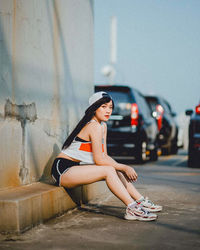 Portrait of young woman sitting outdoors