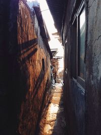 Footpath amidst buildings against sky