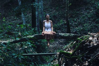 Full length of young woman in forest