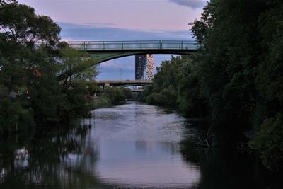 Arch bridge over river against sky