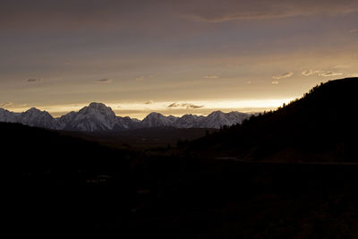 Scenic view of silhouette mountains against sky at sunset