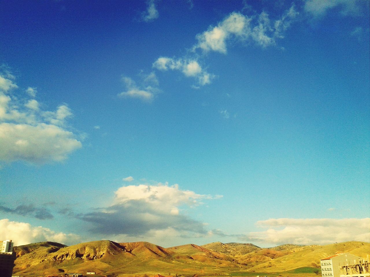 blue, sky, landscape, tranquil scene, tranquility, mountain, scenics, cloud - sky, beauty in nature, nature, cloud, day, non-urban scene, remote, outdoors, low angle view, mountain range, no people, idyllic, built structure