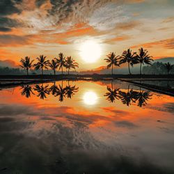 Scenic view of lake against romantic sky at sunset