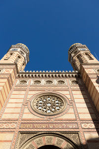 Low angle view of historical building against clear blue sky