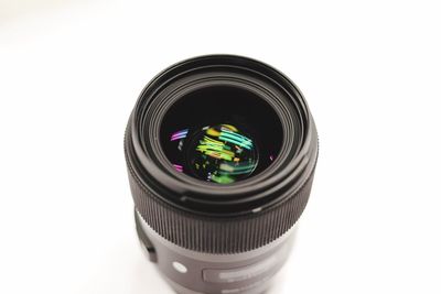 Camera lens against white background