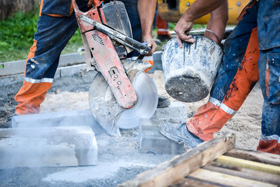 Low section of men working at construction site