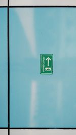 Low angle view of information sign against wall