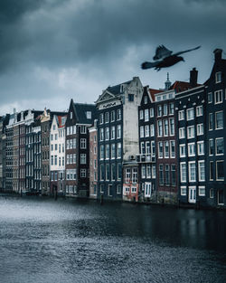 The unique houses of damrak on a cloudy day found in the heart of the dutch capital of amsterdam.