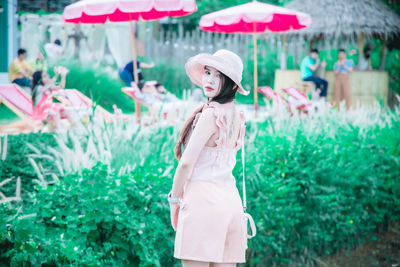 Woman standing by plants