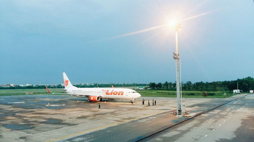 View of airport runway against sky on sunny day