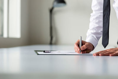 Midsection of man working on table