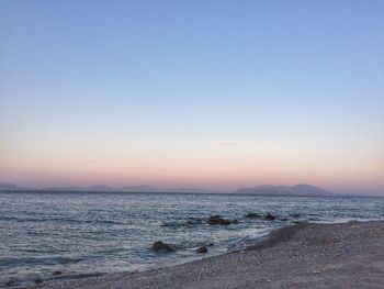 Scenic view of sea against clear sky during sunset