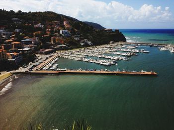 High angle view of sea and cityscape against sky