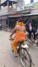 Rear view of people working on street