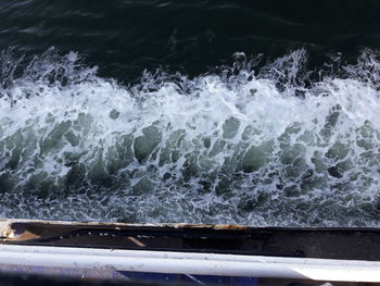 High angle view of waves splashing on rocks