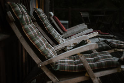 Close-up of empty chairs and tables in warehouse