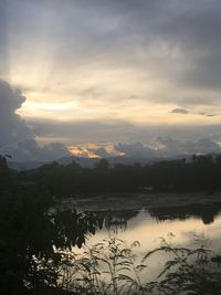 Scenic view of lake against sky at sunset