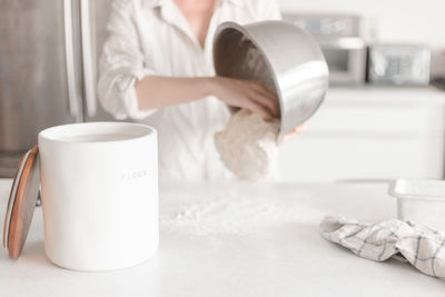 Midsection of woman cooking food at home