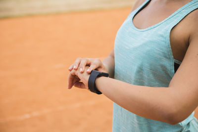 Midsection of woman using mobile phone