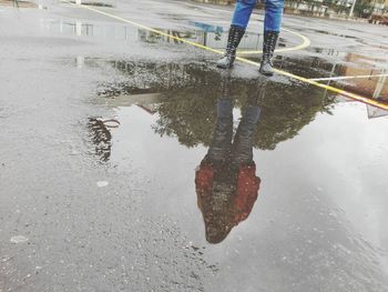 Low section of man working on puddle