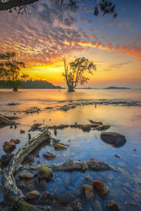 Scenic view of rocks against sky during sunset