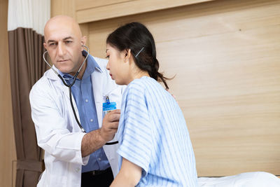 Doctor examining patient in hospital