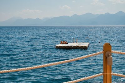 Sailboat in sea against sky