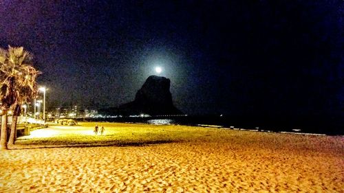 Scenic view of beach against sky at night