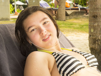 Portrait of smiling girl sitting on lounge chair