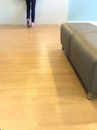 Low section of man standing on hardwood floor