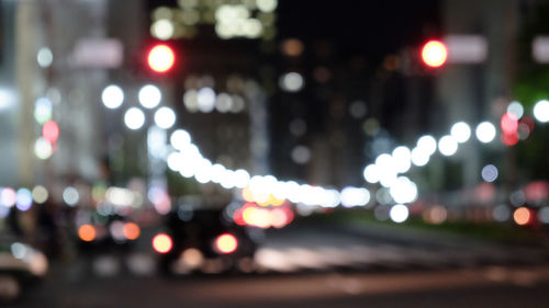 Defocused image of illuminated city street at night