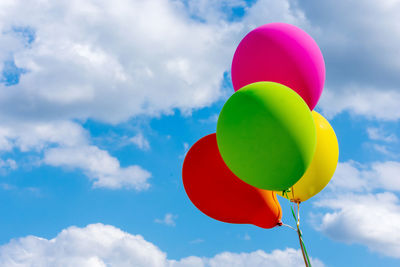 Low angle view of balloons against sky