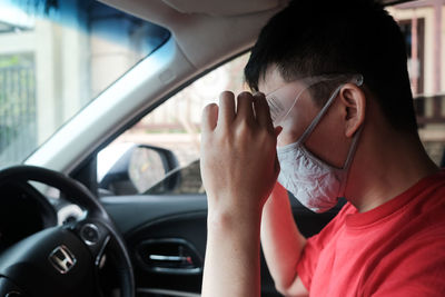 Portrait of man using glasses in car to protection