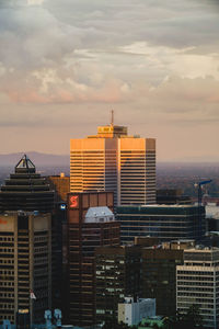 View of skyscrapers against cloudy sky