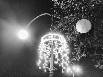 Low angle view of illuminated lights at night