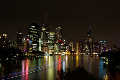 High angle view of light trails on brisbane river against modern buildings