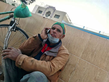 Portrait of young man sitting on bicycle