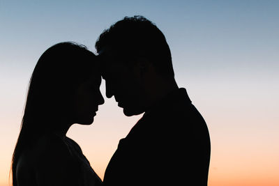 Silhouette couple against sky