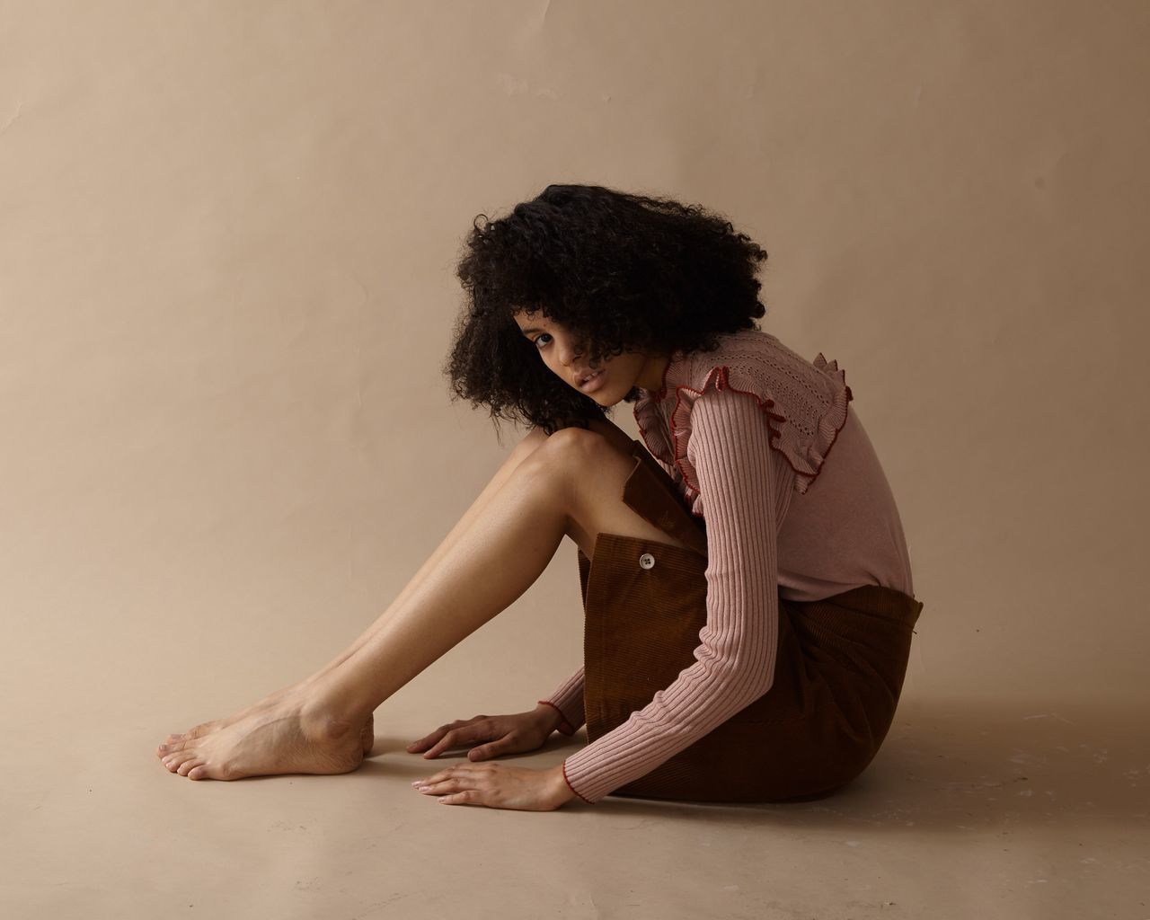 WOMAN SITTING ON WALL