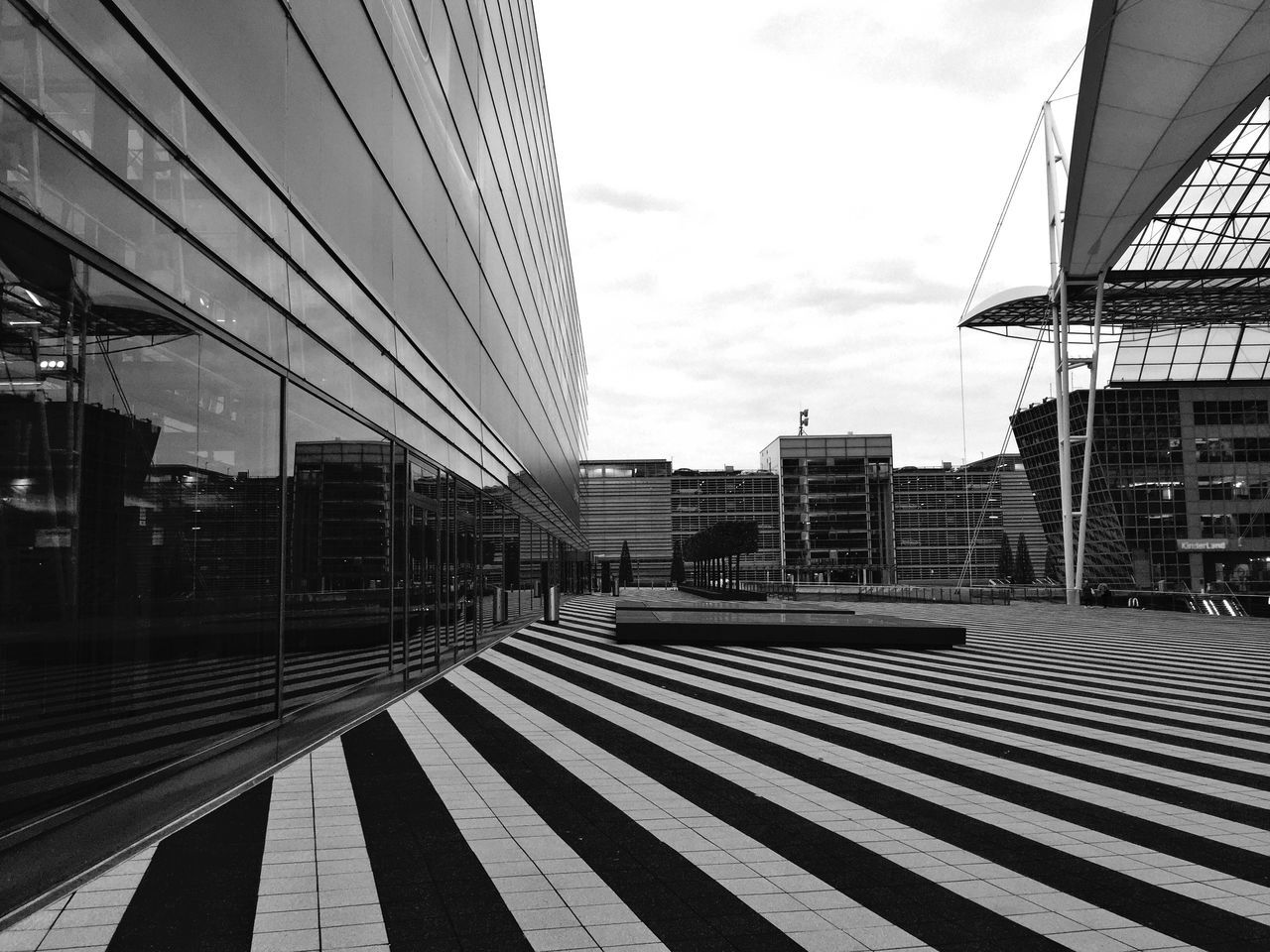 architecture, built structure, building exterior, sky, city, sunlight, railroad track, connection, shadow, the way forward, railing, transportation, railroad station, day, modern, railroad station platform, empty, outdoors, no people, building